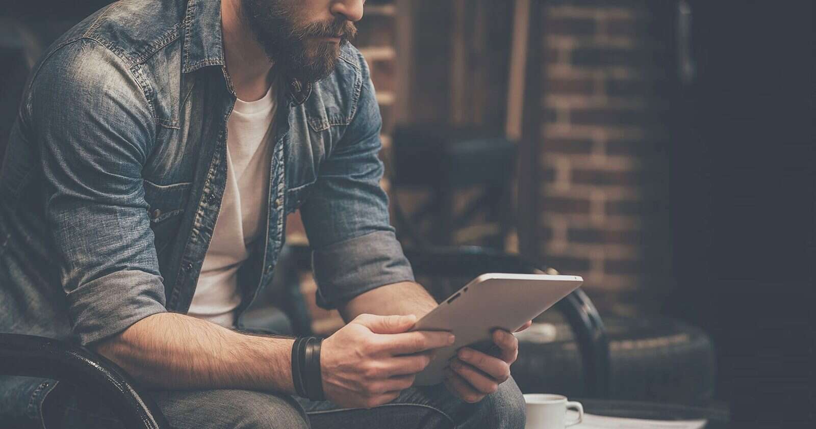 A professional reviewing figures on a tablet
